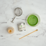 Matcha with tea tools next to it