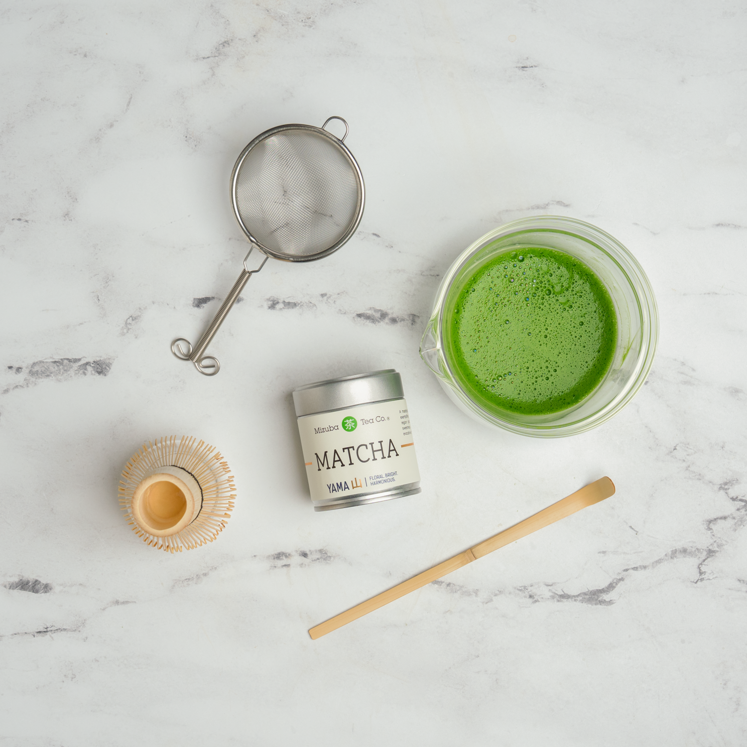 Matcha with tea tools next to it