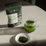 Sencha Loose Leaf tea brewing in teapot on a white table
