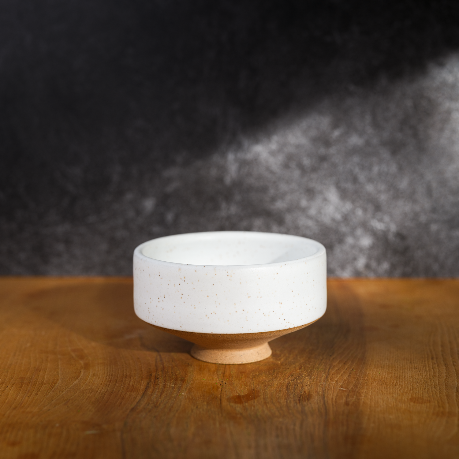 white speckled chawan on a brown table
