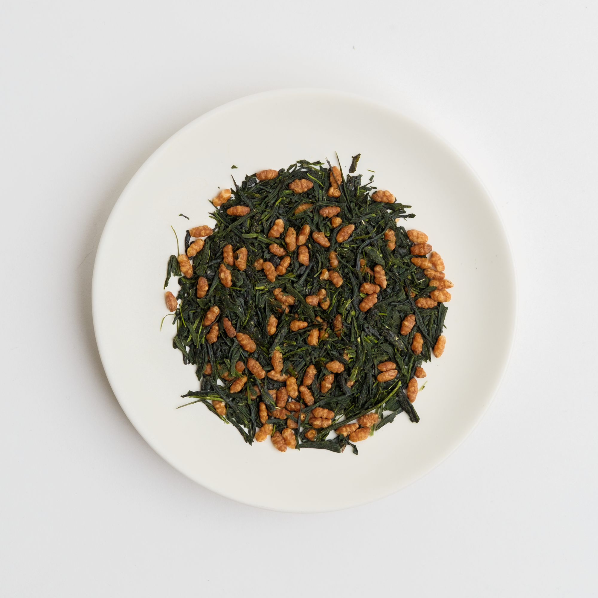 Organic Japanese Genmaicha loose leaf tea on a white plate