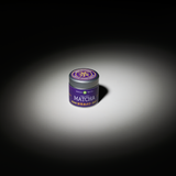 Asahi Matcha powder tin on a white table