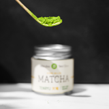 A close up of a chasen matcha school with matcha. 