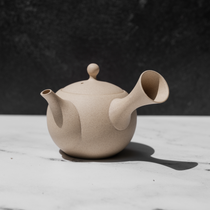 Speckled tea pot on a white surface