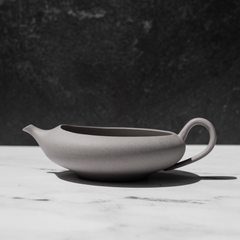 Tea pot for matcha green tea on a white counter