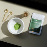 Koshun Matcha powder in a bowl next to a bag of matcha
